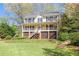 Inviting two-story home featuring a charming front porch, a well-maintained lawn, and mature trees at 4520 Windsor Oaks Dr, Marietta, GA 30066