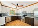 Charming kitchen featuring stainless steel appliances, two-tone cabinetry, and a stylish ceiling fan at 4520 Windsor Oaks Dr, Marietta, GA 30066