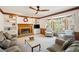 Cozy living room with a brick fireplace, built-in shelves, and a large window offering natural light at 4520 Windsor Oaks Dr, Marietta, GA 30066