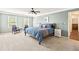 Spacious bedroom featuring a large bed, two windows for lots of light, and room for seating at 4520 Windsor Oaks Dr, Marietta, GA 30066