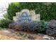 The Windsor Oaks neighborhood sign nestled among green foliage and colorful landscaping at 4520 Windsor Oaks Dr, Marietta, GA 30066