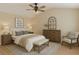 Stylishly furnished bedroom features neutral tones and ceiling fan at 7112 Brookview Way, Riverdale, GA 30274