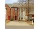 Two-story brick townhome with a front yard and driveway, showcasing its classic architectural details at 7112 Brookview Way, Riverdale, GA 30274