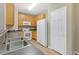 Kitchen features oak cabinets, white appliances, tile counters, and stainless steel sink providing an easy to clean area at 7112 Brookview Way, Riverdale, GA 30274