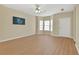 Spacious living room with neutral paint, hardwood floors, large windows and lots of space to personalize at 7112 Brookview Way, Riverdale, GA 30274