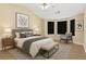 Inviting main bedroom features a sitting area, and neutral color palette creating a calm and inviting space at 7112 Brookview Way, Riverdale, GA 30274
