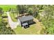 Scenic aerial view of a gray home with a long driveway and lush greenery at 719 Fairview Rd, Brooks, GA 30205