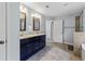 Large main bathroom with double sinks, tile flooring, and a glass-enclosed shower at 719 Fairview Rd, Brooks, GA 30205