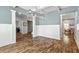 Open dining room featuring a modern chandelier, paneled wainscoting, and luxury vinyl plank flooring at 719 Fairview Rd, Brooks, GA 30205