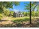 Charming gray home with a inviting front porch surrounded by trees and lawn at 719 Fairview Rd, Brooks, GA 30205