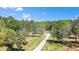 Beautiful two-story home featuring a long driveway and surrounded by lush trees at 719 Fairview Rd, Brooks, GA 30205