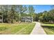 Charming two-story gray home with a long driveway and landscaped front yard at 719 Fairview Rd, Brooks, GA 30205