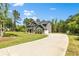 A well-maintained two-story home with a long driveway and green lawn at 719 Fairview Rd, Brooks, GA 30205