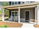 Charming front porch with rocking chairs, offering a cozy and inviting entryway to the home at 719 Fairview Rd, Brooks, GA 30205