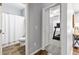 Hallway view of a bathroom and room with carpeted floor and treadmill equipment at 719 Fairview Rd, Brooks, GA 30205