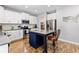 Modern kitchen with white cabinets, stainless steel appliances, and a stylish island with bar seating at 719 Fairview Rd, Brooks, GA 30205