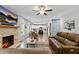 Inviting living room featuring a brick fireplace, comfortable leather sofas, and an open layout at 719 Fairview Rd, Brooks, GA 30205