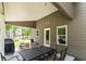 Covered patio with dining area and grill, perfect for outdoor entertaining at 719 Fairview Rd, Brooks, GA 30205