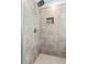 Detailed view of the tiled shower with a rainfall showerhead and built-in niche at 719 Fairview Rd, Brooks, GA 30205