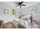 Bright bedroom featuring two windows, hardwood floors, and a ceiling fan at 912 Fairburn Nw Rd, Atlanta, GA 30331