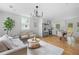 Open-concept living and dining area with hardwood floors and modern lighting at 912 Fairburn Nw Rd, Atlanta, GA 30331