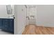 Hallway leading to modern bathroom featuring blue cabinets and wood floors at 195 Childs Nw Dr, Atlanta, GA 30314