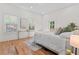 Bright bedroom featuring wood floors, two windows, and a glass-topped table, offering a serene retreat at 195 Childs Nw Dr, Atlanta, GA 30314
