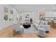 Open-concept living space with hardwood floors, a cozy seating area, and a view into the kitchen and dining area at 195 Childs Nw Dr, Atlanta, GA 30314
