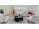 Open-concept living space with hardwood floors, a cozy seating area, and a view into the kitchen and dining area at 195 Childs Nw Dr, Atlanta, GA 30314
