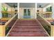Inviting brick steps lead to a covered porch with railings and black fans on the ceiling at 195 Childs Nw Dr, Atlanta, GA 30314