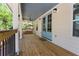 Inviting covered porch featuring a ceiling fan, wood flooring and charming, light blue double doors at 195 Childs Nw Dr, Atlanta, GA 30314