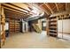 Large unfinished basement featuring exposed utilities, wooden beams, and shelving at 2846 Spring Lake Dr, Buford, GA 30519