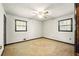 Bedroom featuring neutral carpet, ceiling fan, and two windows at 2846 Spring Lake Dr, Buford, GA 30519