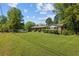 Charming brick home featuring a lush, expansive front yard and mature trees under a sunny sky at 2846 Spring Lake Dr, Buford, GA 30519
