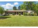 Charming brick home featuring a well-manicured lawn and mature trees at 2846 Spring Lake Dr, Buford, GA 30519