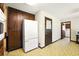 Kitchen featuring a white refrigerator, wooden cabinets, and doorway to a laundry room at 2846 Spring Lake Dr, Buford, GA 30519