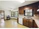 Retro kitchen with wooden cabinets, white appliances, a double basin sink and window overlooking the front yard at 2846 Spring Lake Dr, Buford, GA 30519
