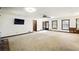 Large living room featuring neutral carpet and multiple windows at 2846 Spring Lake Dr, Buford, GA 30519