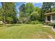An expansive yard features a single story home with trees and greenery surrounding the property at 2846 Spring Lake Dr, Buford, GA 30519