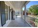 Spacious balcony featuring tiled floors, classic columns, and views of the surrounding greenery and neighborhood at 3890 The Battery, Duluth, GA 30096