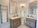 Bathroom featuring dual vanities and large mirrors with sconce lighting at 3890 The Battery, Duluth, GA 30096