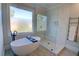 Bathroom featuring a sleek standalone tub and frameless glass shower at 3890 The Battery, Duluth, GA 30096