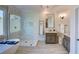 Bright primary bathroom featuring dual vanities, tub and frameless glass shower at 3890 The Battery, Duluth, GA 30096
