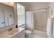 Bright bathroom features a shower-tub combo with white tile surround and a framed mirror at 3890 The Battery, Duluth, GA 30096