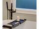 Close up of bathtub with black fixtures and a caddy holding a candle and towels at 3890 The Battery, Duluth, GA 30096