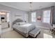 Charming bedroom featuring an ensuite bathroom and a soft color palette with tufted headboard at 3890 The Battery, Duluth, GA 30096