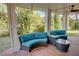 Inviting covered porch featuring brick flooring, comfortable seating, and serene backyard views at 3890 The Battery, Duluth, GA 30096
