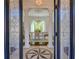Elegant dining room view through decorative glass doors, highlighting columns, chandelier, and natural light at 3890 The Battery, Duluth, GA 30096