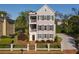 Charming three-story home features black window shutters, dual balconies and a manicured front yard at 3890 The Battery, Duluth, GA 30096