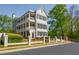 Stately three-story home with elegant balconies and meticulously landscaped front yard, complete with wrought iron fence at 3890 The Battery, Duluth, GA 30096